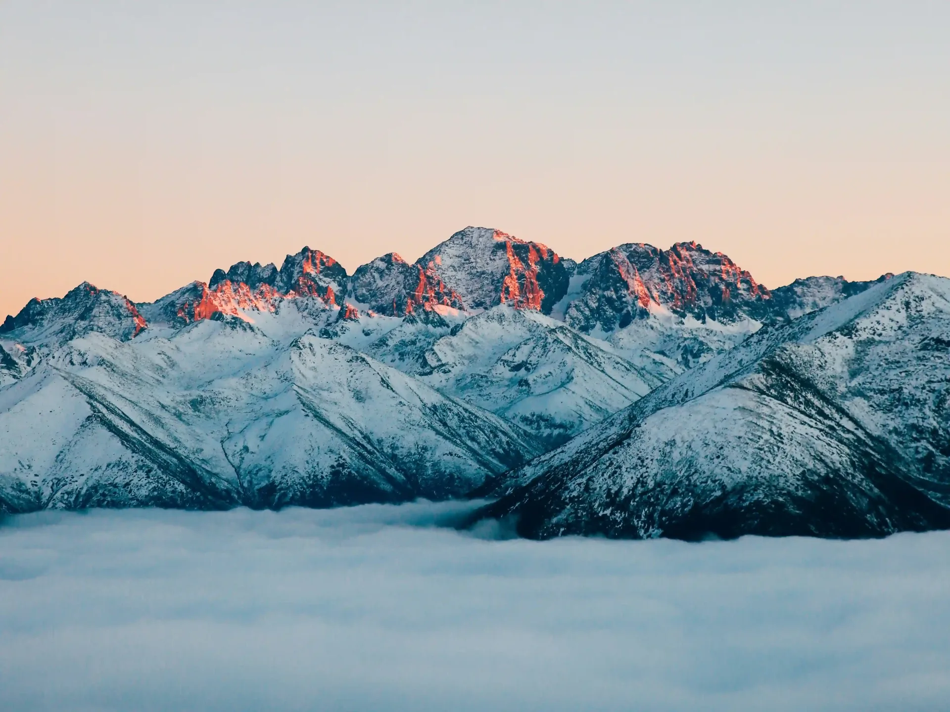 Snow-capped peaks above clouds